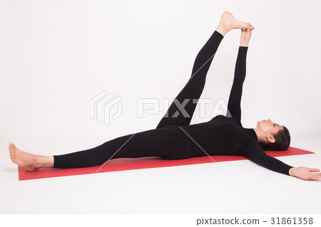 Beautiful athletic girl in black suit doing yoga Beautiful athletic girl in black suit doing yoga 31861358