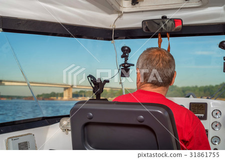 Back view of river boat driver Back view of river boat driver 31861755