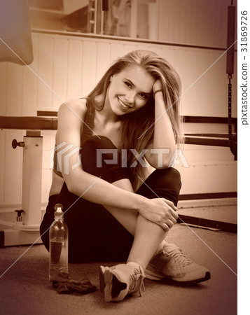 Women drink water at gym. Girl resting after 31869726