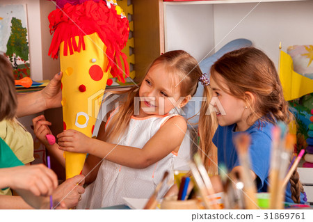 Child painting on table. Girl make candy cone Child painting on table. Girl make candy cone 31869761