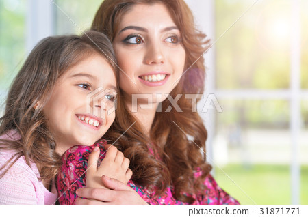 young mother hugging little daughter young mother hugging little daughter 31871771