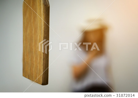 Close up of Wood Bell Lumber and blurred woman Close up of Wood Bell Lumber and blurred woman 31872014