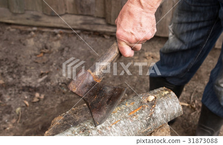 an elderly man with an old axe chops firewood an elderly man with an old axe chops firewood 31873088