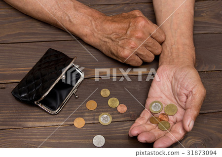 An elderly person holds the coins An elderly person holds the coins 31873094