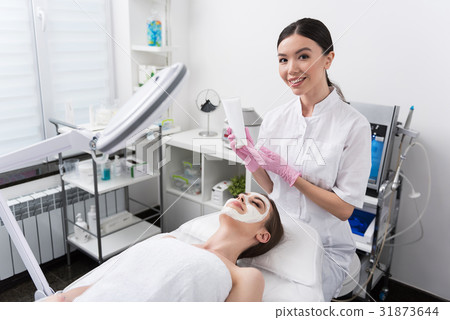 Joyful cosmetologist is working with client at spa Joyful cosmetologist is working with client at spa 31873644