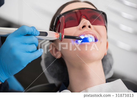 Doctor examining mouth of outgoing female 31873813