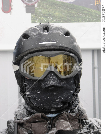 Skiier wearing a helmet and goggles Skiier wearing a helmet and goggles 31873874