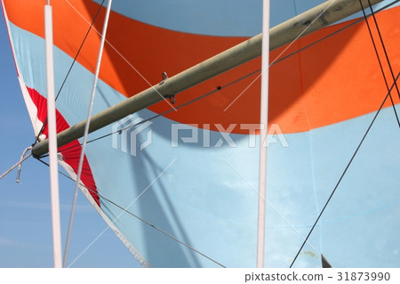 orange and white stripey sail on the end of a pole orange and white stripey sail on the end of a pole 31873990