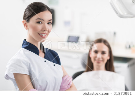 Outgoing dentist standing in room Outgoing dentist standing in room 31873991