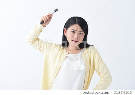 An angry young woman getting angry with a hammer An angry young woman getting angry with a hammer 31874166