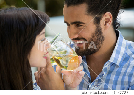 Happy man and woman drinking wine in park Happy man and woman drinking wine in park 31877223