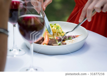 Woman having lunch at outdoor restaurant 31877238