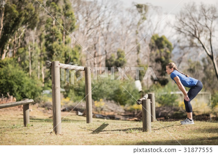 Woman standing with her hands on hip at boot camp 31877555