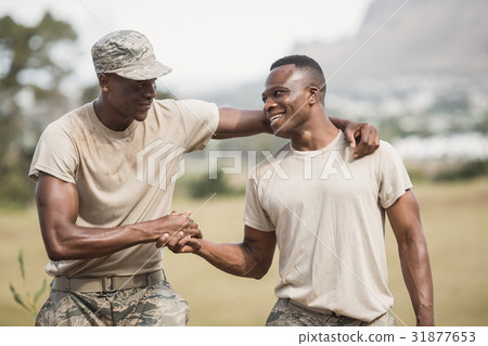 Military soldiers shaking hands during obstacle course 31877653