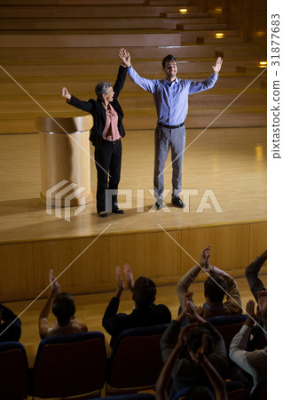 Female business executive appreciating a colleague on stage 31877683