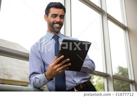Businessman using digital tablet Businessman using digital tablet 31877712