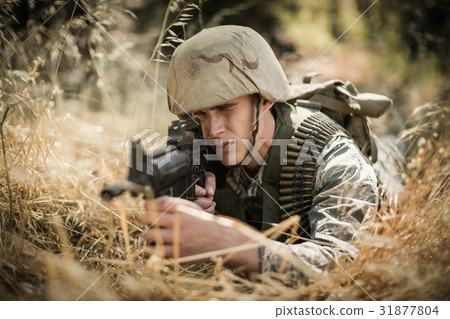 Military soldier aiming with a rifle 31877804