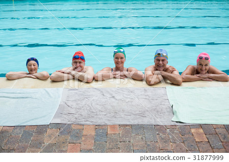Senior swimmers leaning on poolside 31877999
