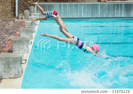 Children diving in water at poolside Children diving in water at poolside 31878228