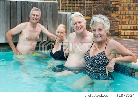 Swimmers leaning on poolside 31878524