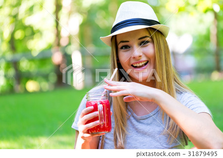 Young woman drinking smoothie Young woman drinking smoothie 31879495