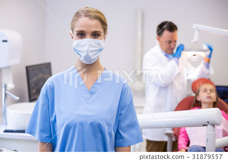 Portrait of female nurse wearing surgical mask Portrait of female nurse wearing surgical mask 31879557