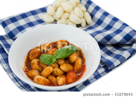 Close up of gnocchi pasta in bowl on napkin Close up of gnocchi pasta in bowl on napkin 31879643