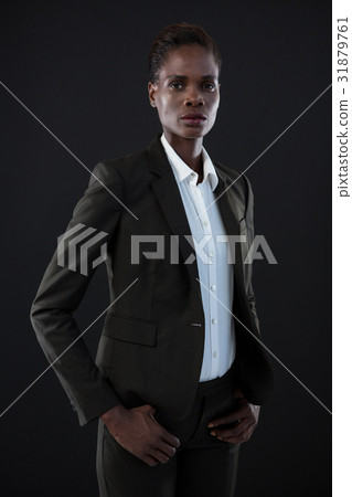 Androgynous man in suit posing against grey background Androgynous man in suit posing against grey background 31879761