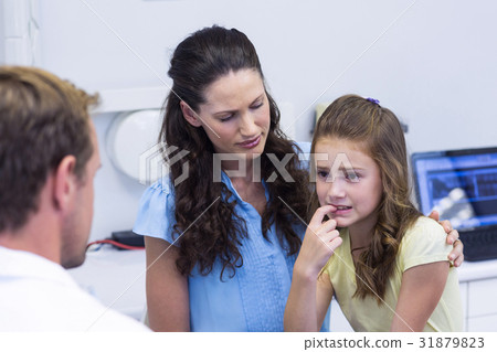 Young patient showing teeth to dentist Young patient showing teeth to dentist 31879823