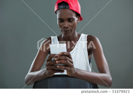 Androgynous man using mobile phone 31879921