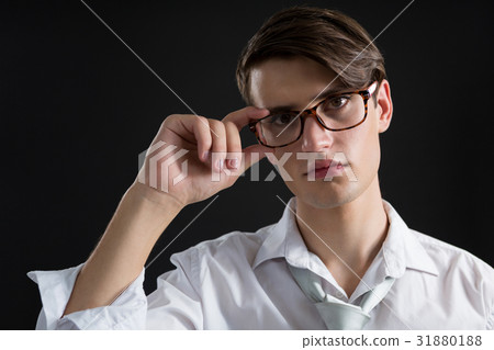 Androgynous man posing in spectacles 31880188