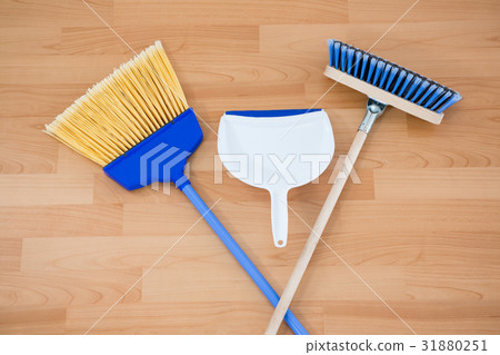 Overhead view of brooms with dustpan on floor 31880251