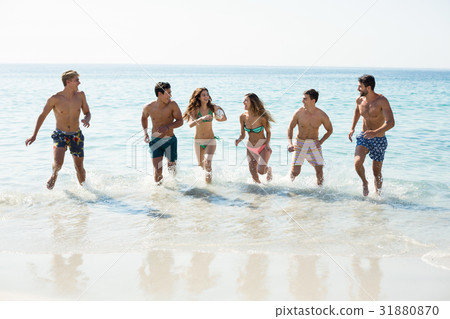 Friends running on shore Friends running on shore 31880870