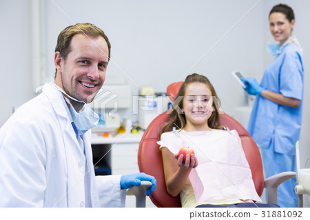 Portrait of smiling dentists and young patient Portrait of smiling dentists and young patient 31881092