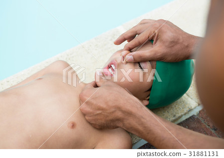 Lifeguard assisting unconscious boy Lifeguard assisting unconscious boy 31881131