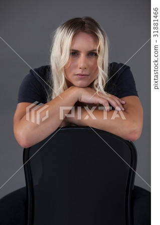Portrait of beautiful transgender woman leaning on chair 31881466