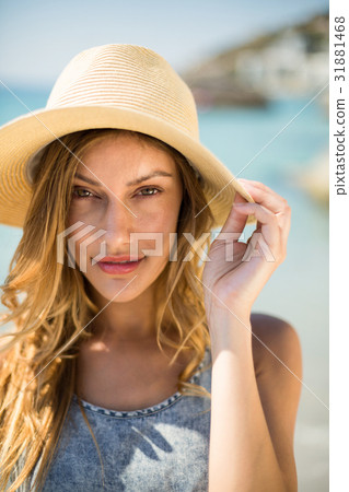 Portrait of young woman wearing sun hat 31881468