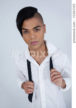 Portrait of confident transgender woman holding tie 31881505