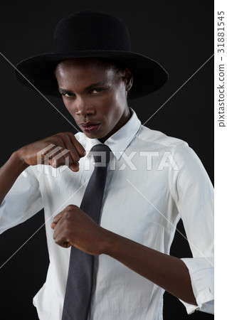 Androgynous man posing against grey background 31881545