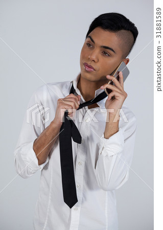 Transgender woman holding tie while using phone Transgender woman holding tie while using phone 31881589