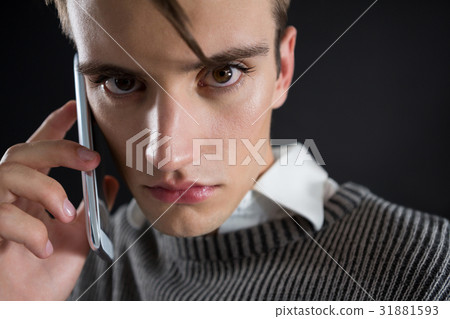 Angry androgynous man talking on mobile phone 31881593