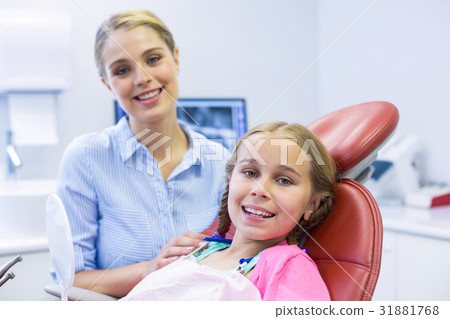 Smiling mother and daughter at dental clinic 31881768