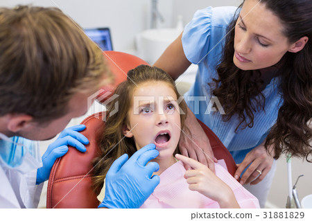 Dentist examining young patient Dentist examining young patient 31881829