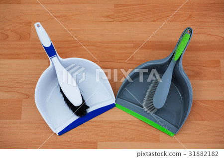 Overhead view of brushs with dustpans on hardwood floor 31882182