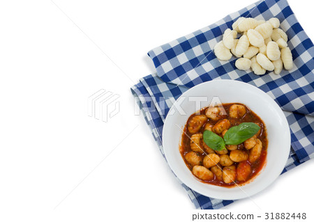 Overhead view of gnocchi pasta in bowl on napkin Overhead view of gnocchi pasta in bowl on napkin 31882448