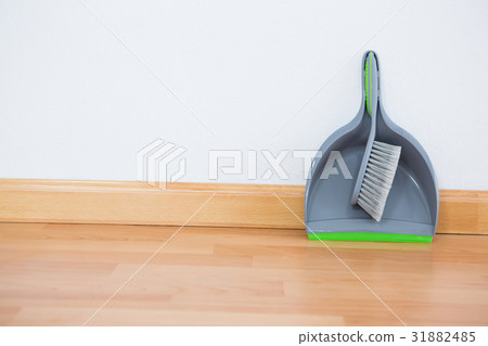 Close up of brush and dustpan against wall 31882485
