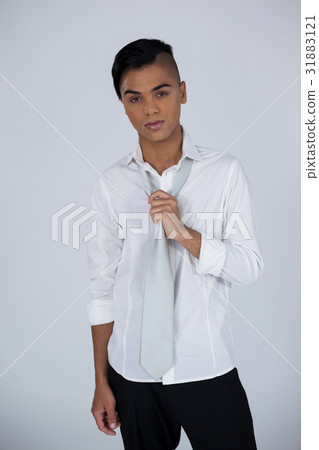 Portrait of transgender woman holding tie 31883121