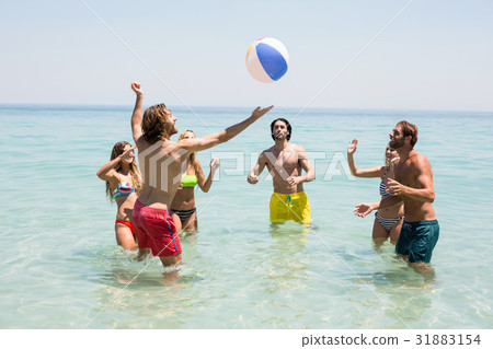 Friends playing with ball in sea 31883154