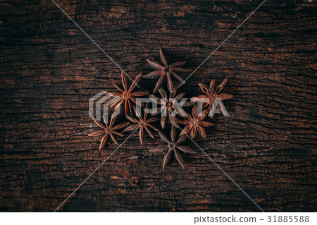 Anise stars on wood background. 31885588