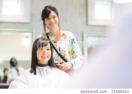 Young female hairdresser and female customer 31886563